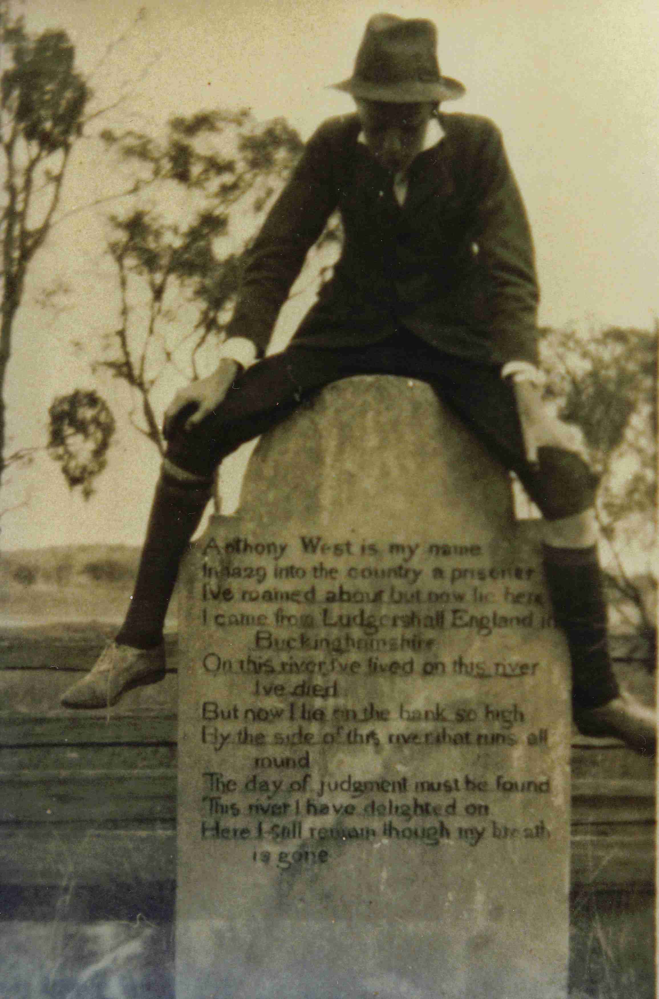 Stanley Nevell sitting on Anthony West's headstone at Deridgerr